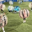 Team von Kindern spielt Bumper Ball bei einer Vereinsfeier auf Rasen