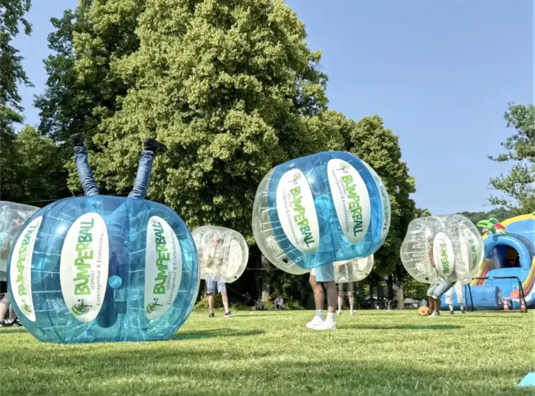 Spieler kopfüber beim Bumperball oder Bubble Soccer Fußall Teambuilding Event am Seaside Beach Baldeney See